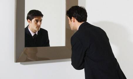 businessman-looking-in-mirror